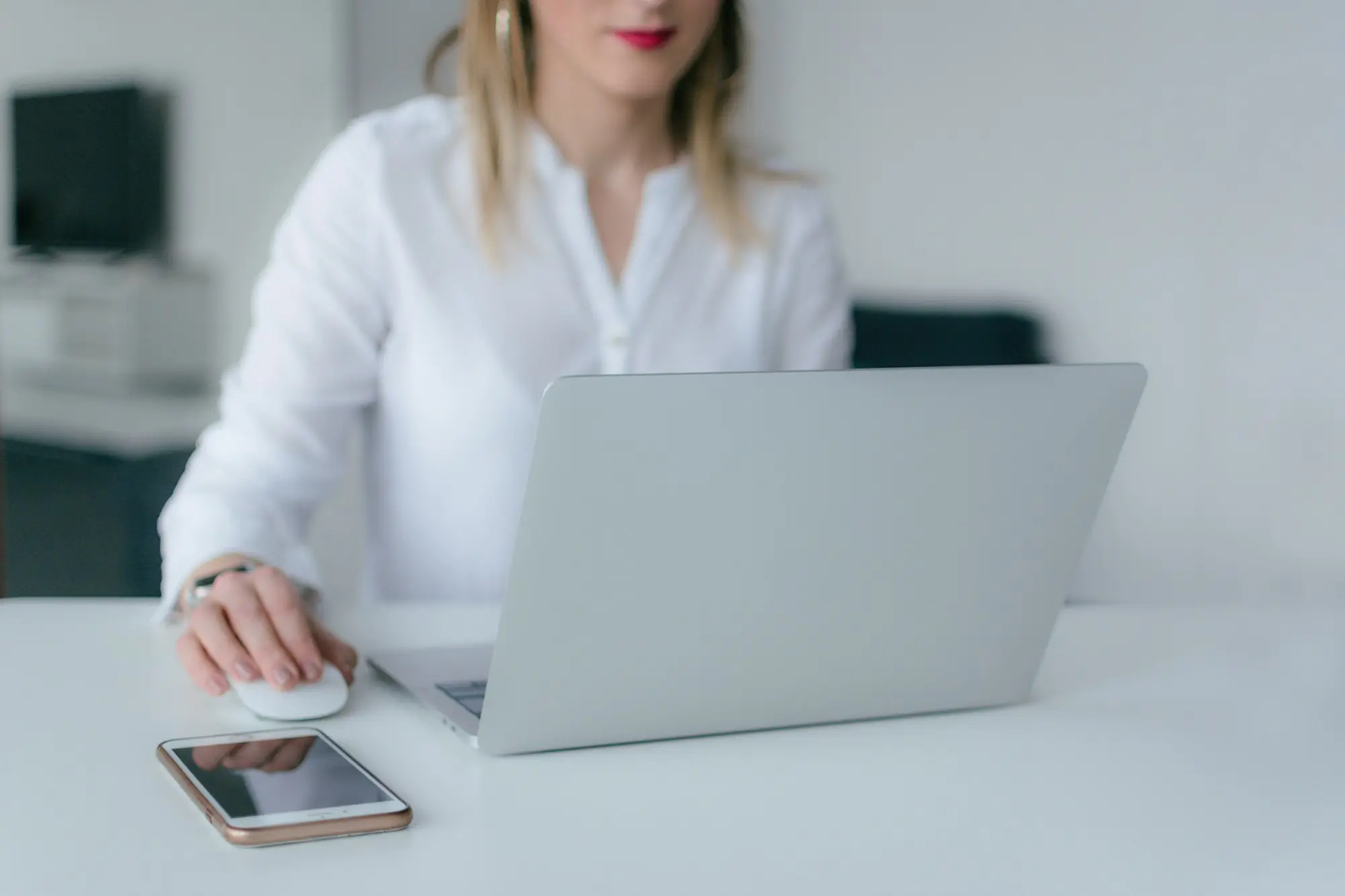 Business owner chasing an invoice by phone at her desk