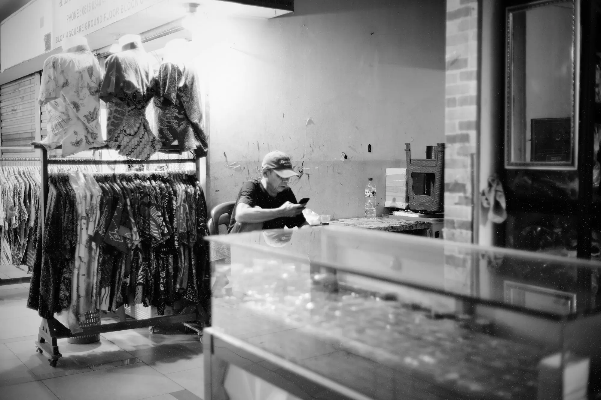 Retail owner calling customers during a quiet spell in the shop