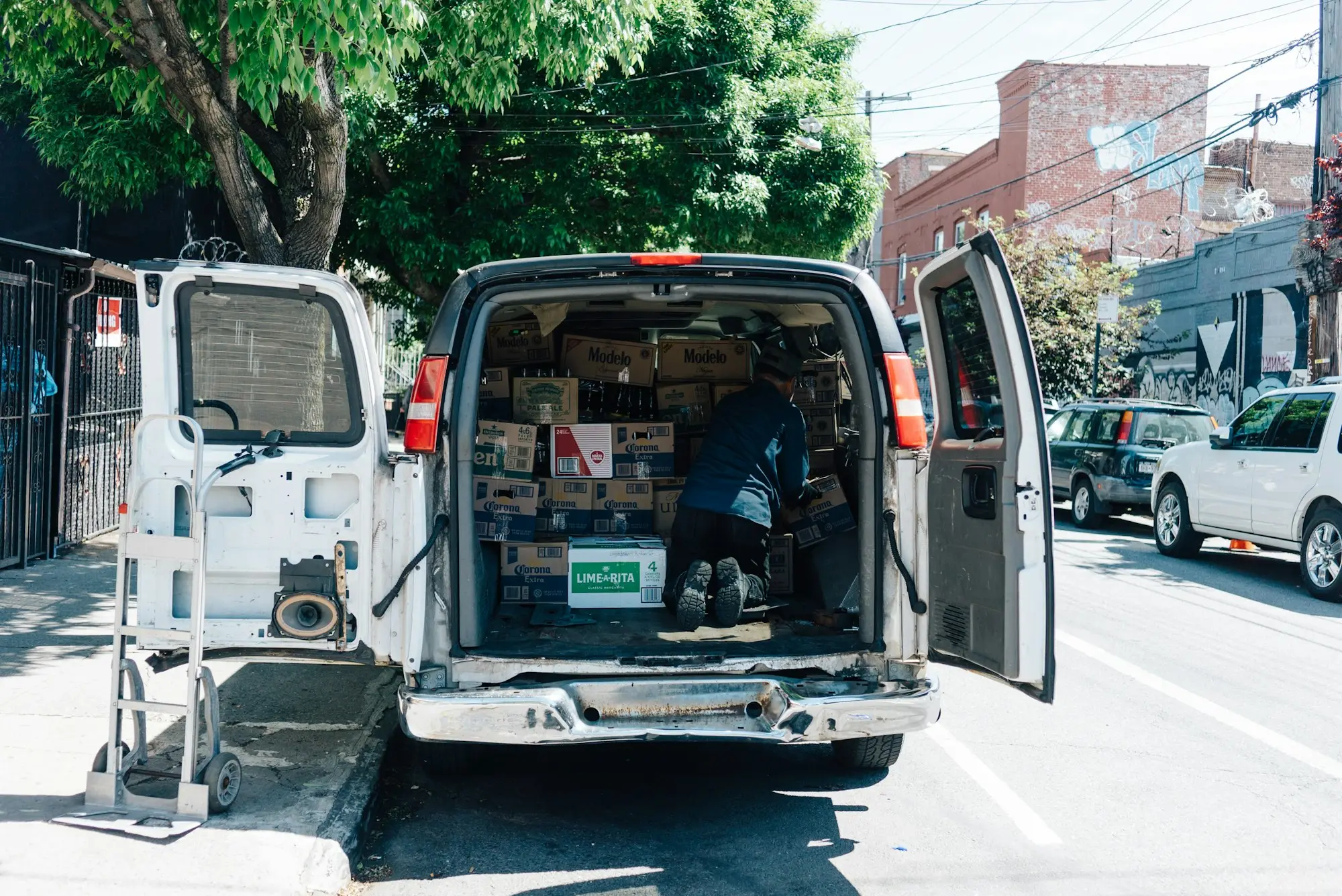 Tradie's van parked with the back doors open and tools loaded
